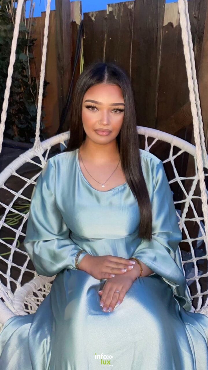 Shamsy Oukrad en robe satinée bleu pâle, dans un fauteuil suspendu