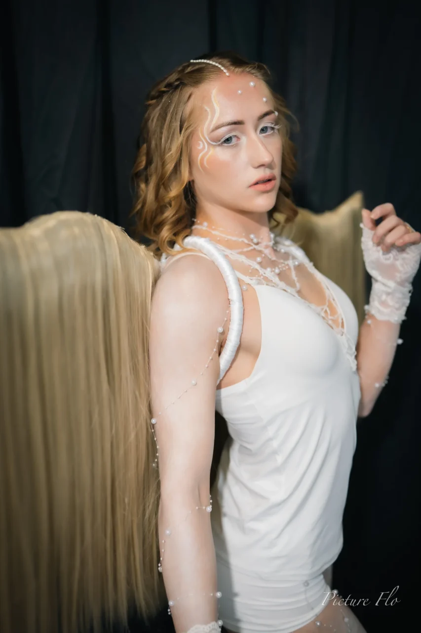 In the studio, three-quarter view, lace gloves and wings on her back
