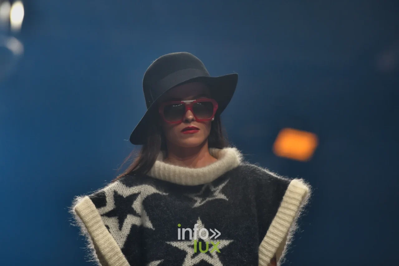 Damlaws, „The Dam Star“. Schwarzer ärmelloser Pullover mit großen weißen Sternen, ecrufarbener Rollkragen, schwarzer Hut
